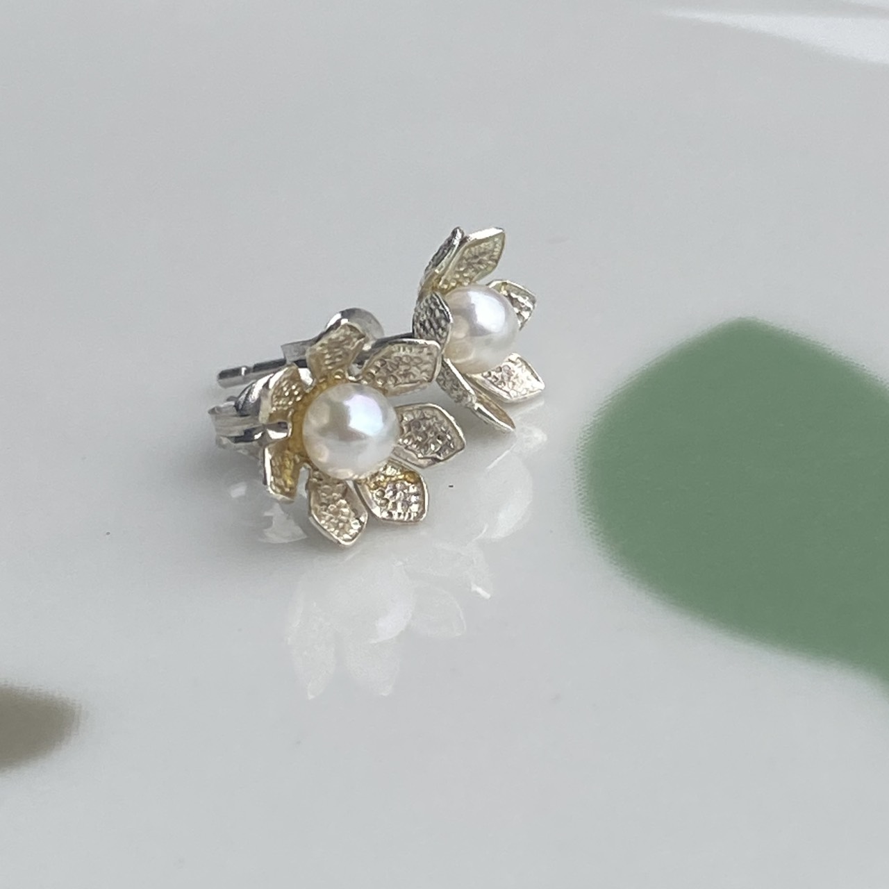 Sterling silver petals surrounding small Akoya pearls