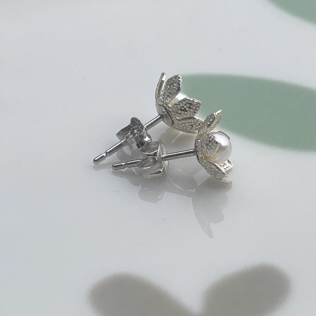 Small Japanese Akoya pearls in silver flower stud earrings