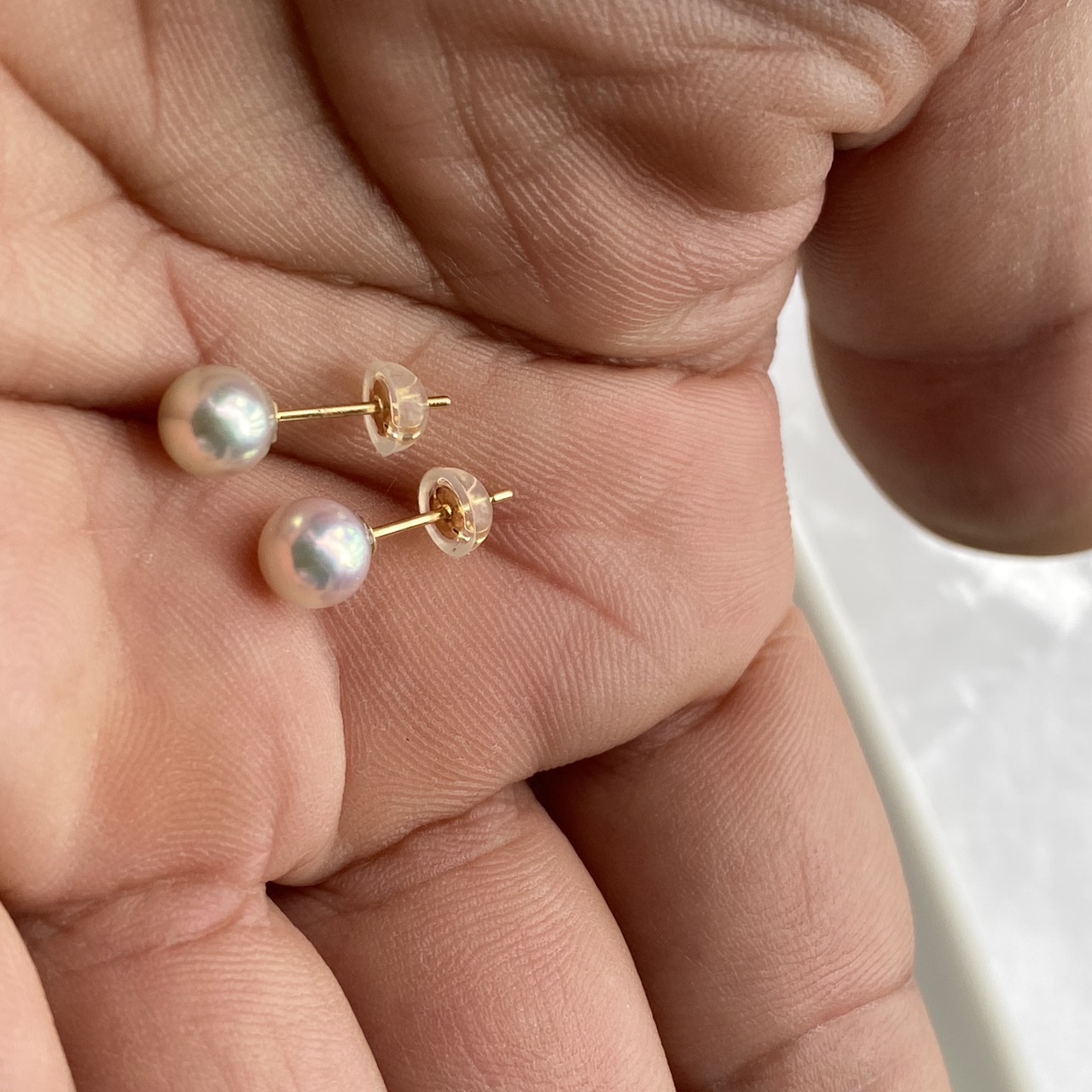 6 mm natural blue Akoya pearl stud earrings held in hand