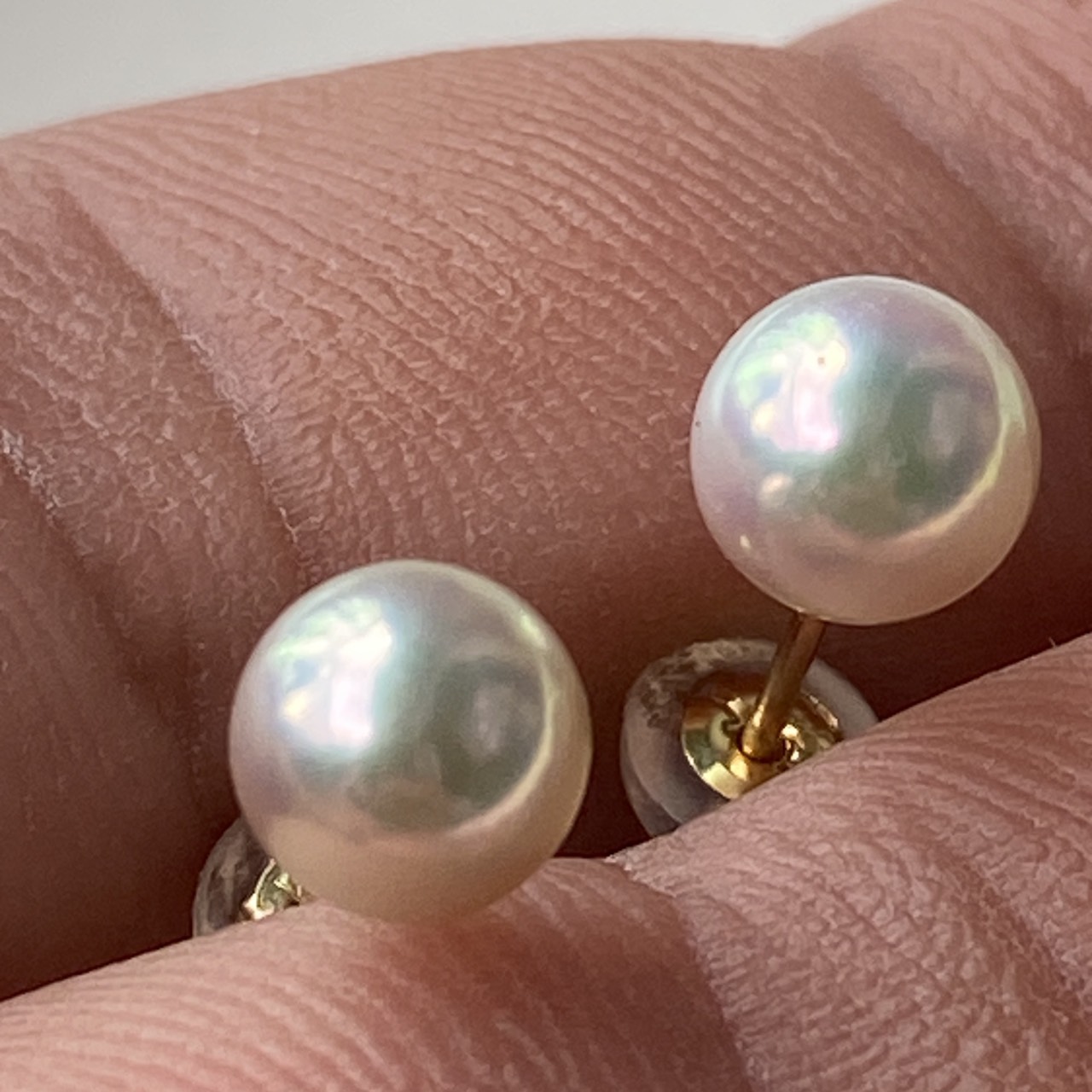 Close view of two round natural blue Akoya pearls