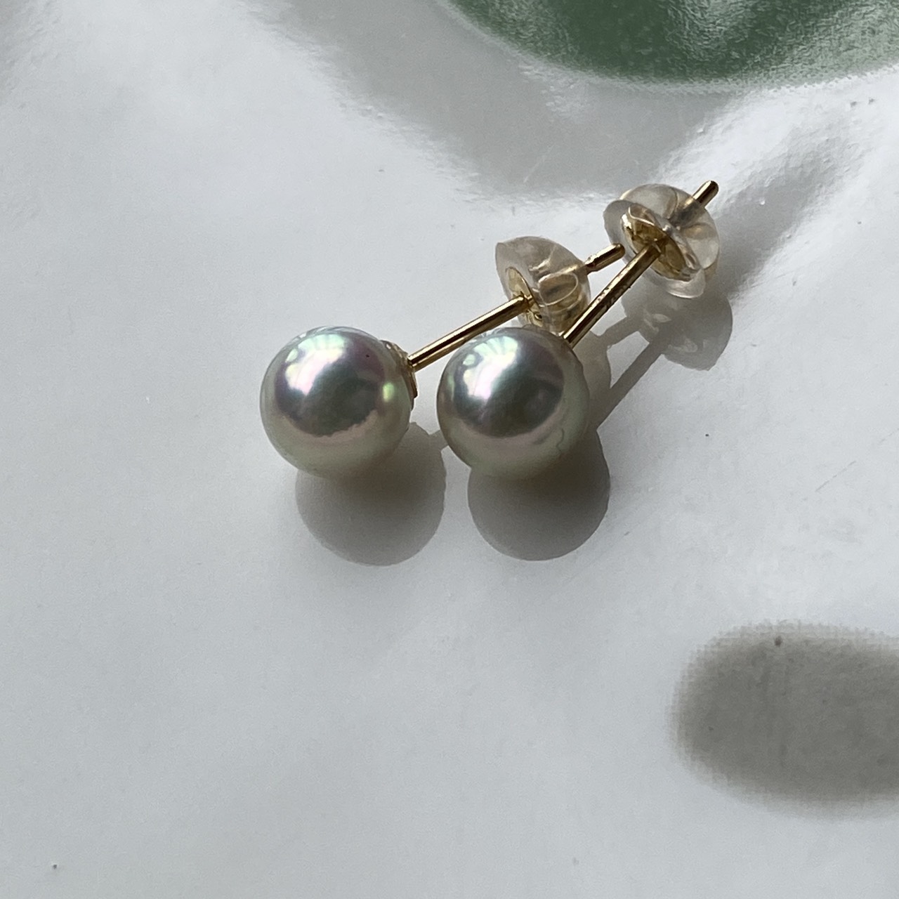 Round Akoya pearl studs showing gentle blue luster