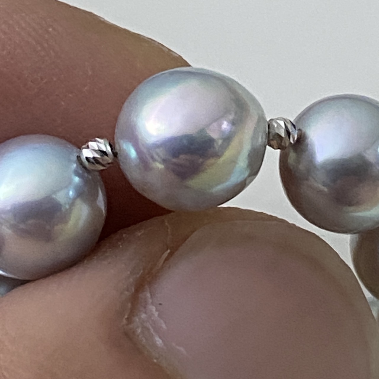 Macro view of a baroque natural blue Akoya pearl and white gold accents