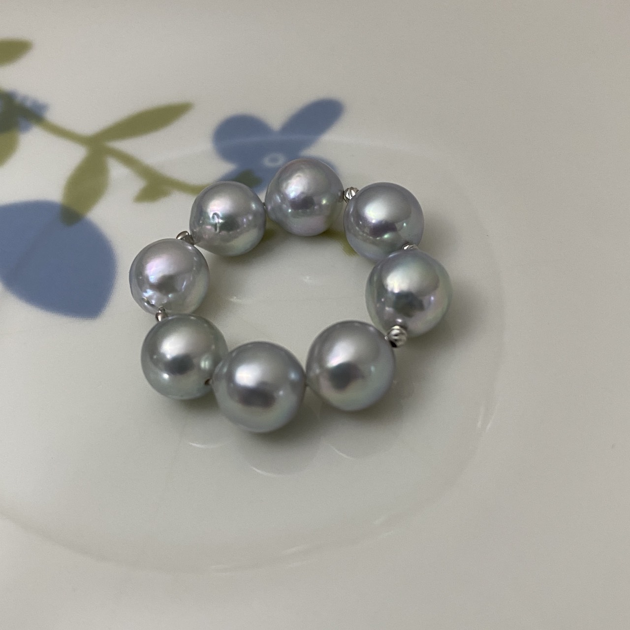 Full view of the statement pearl ring arranged on a floral dish