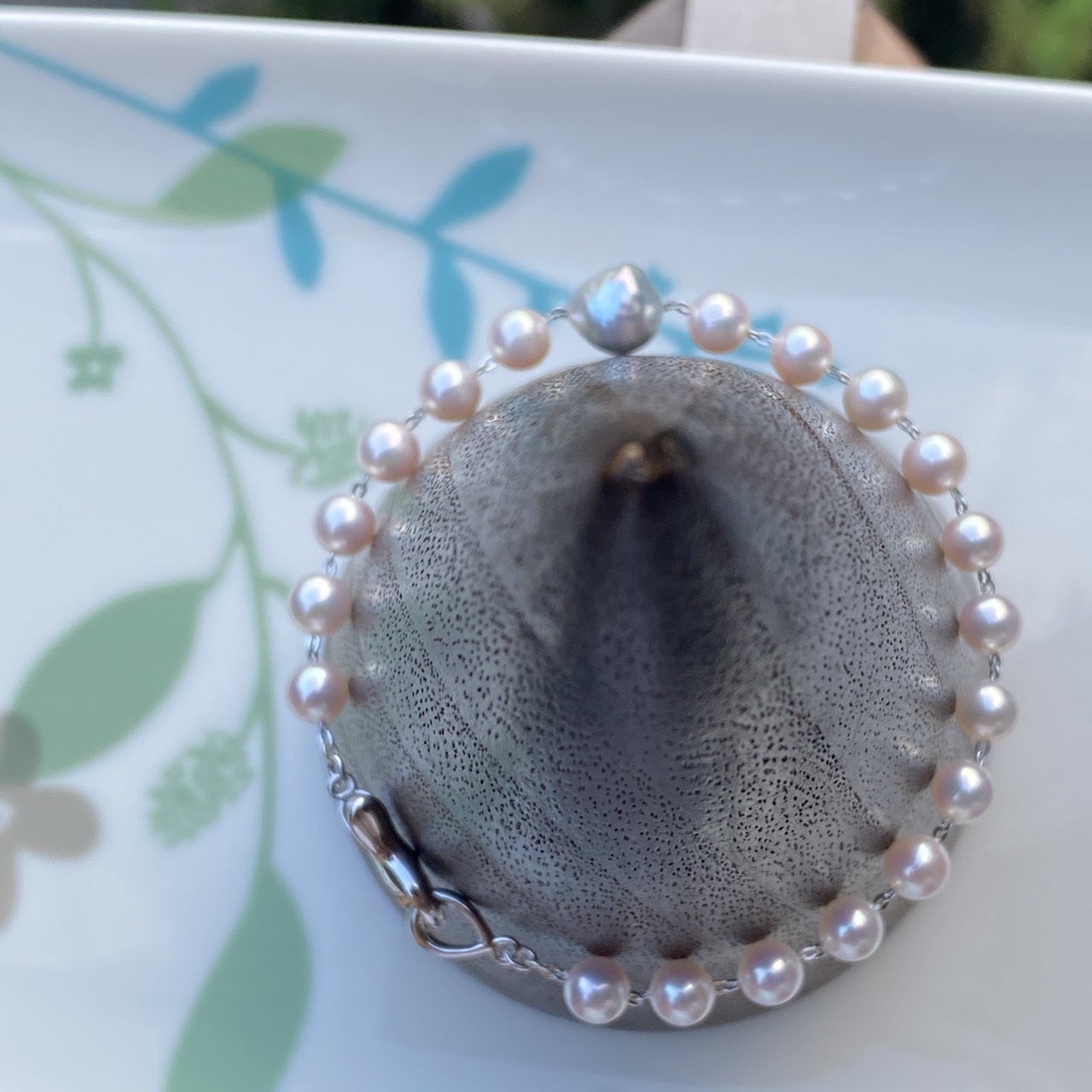 Morning Dream Akoya pearl bracelet arranged around a gray spherical display