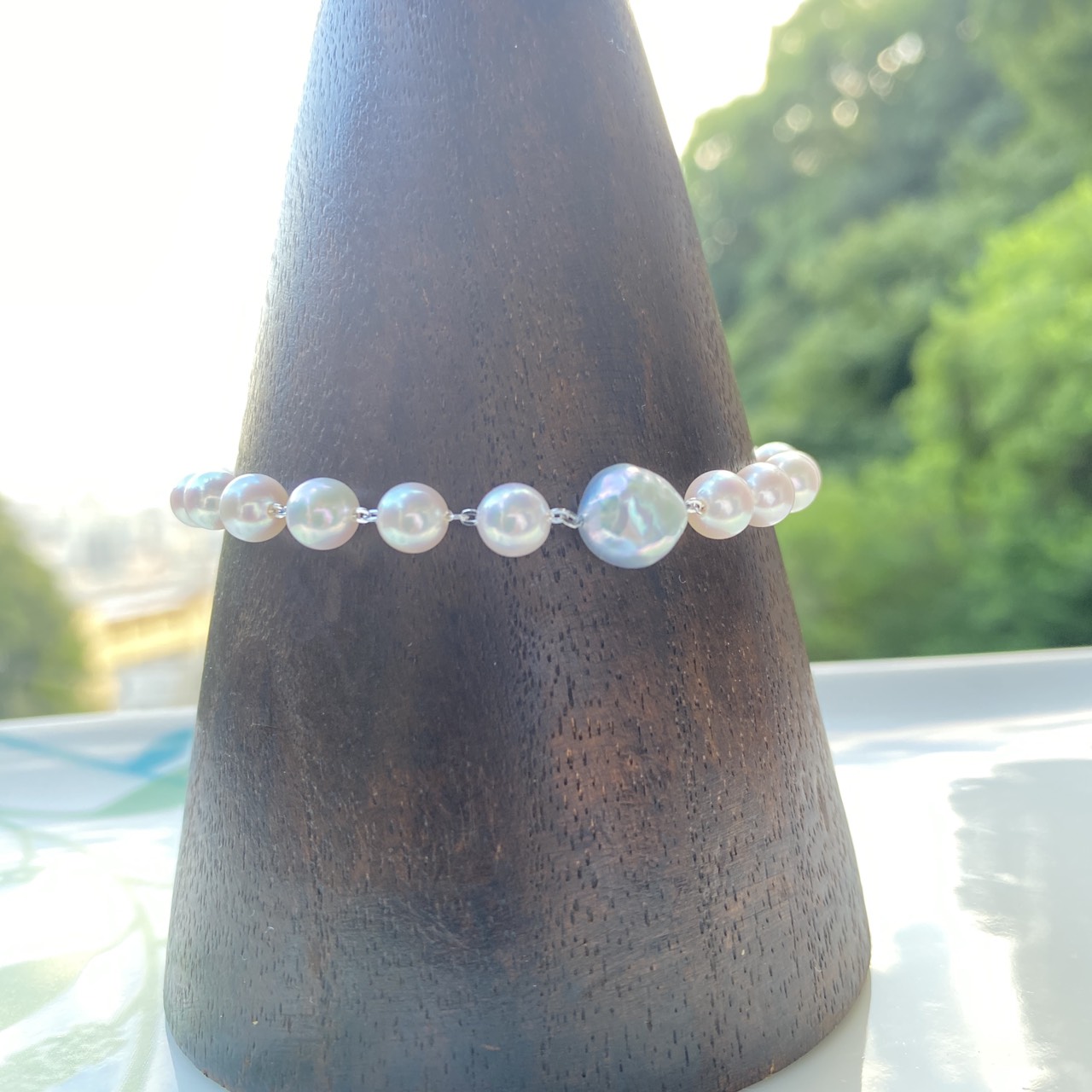 Natural blue baroque Akoya pearl accent among white-pink pearls